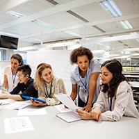 Group of female coworkers meeting around a table in an office