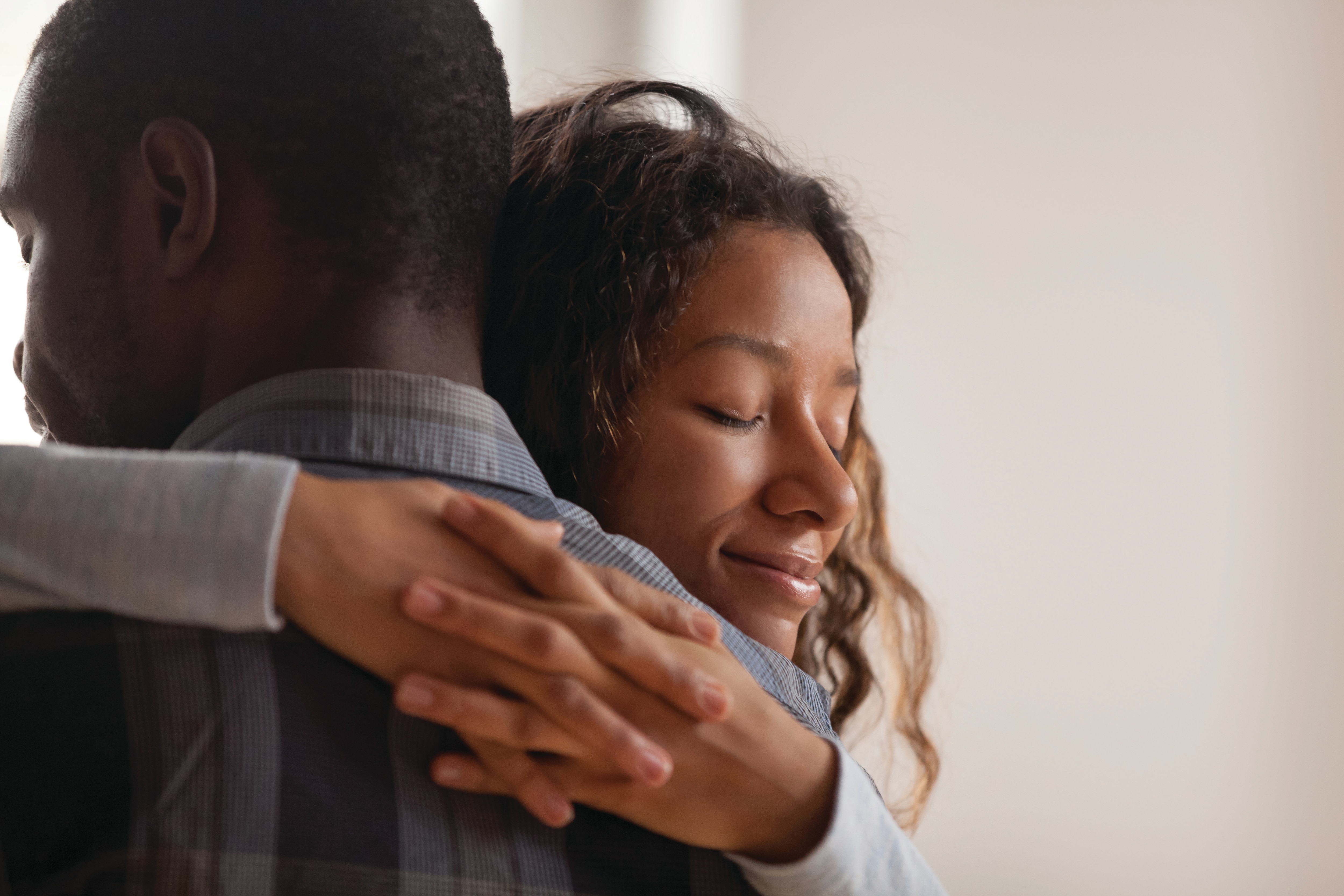 African American man and woman hugging.