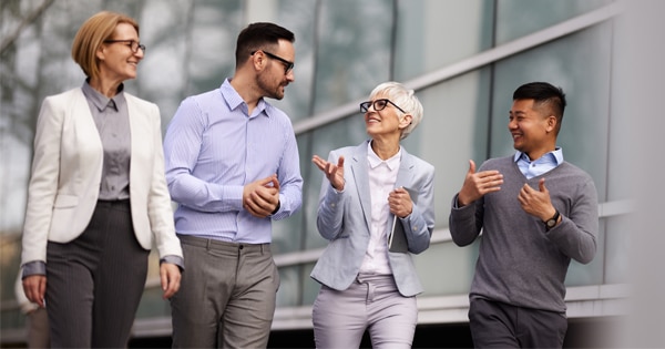 A group of coworkers walking and talking