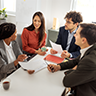 Two businessmen and two businesswomen meeting in an office