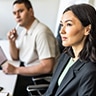 Man and Woman looking at off-screen presentation