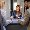 Group of coworkers smiling across a desk